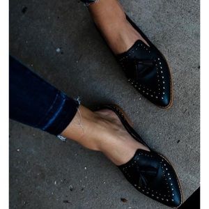 Studded and tasseled black leather loafers.